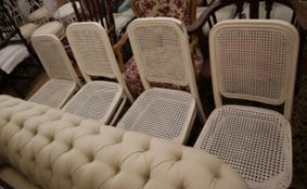 A set of four painted caned chairs