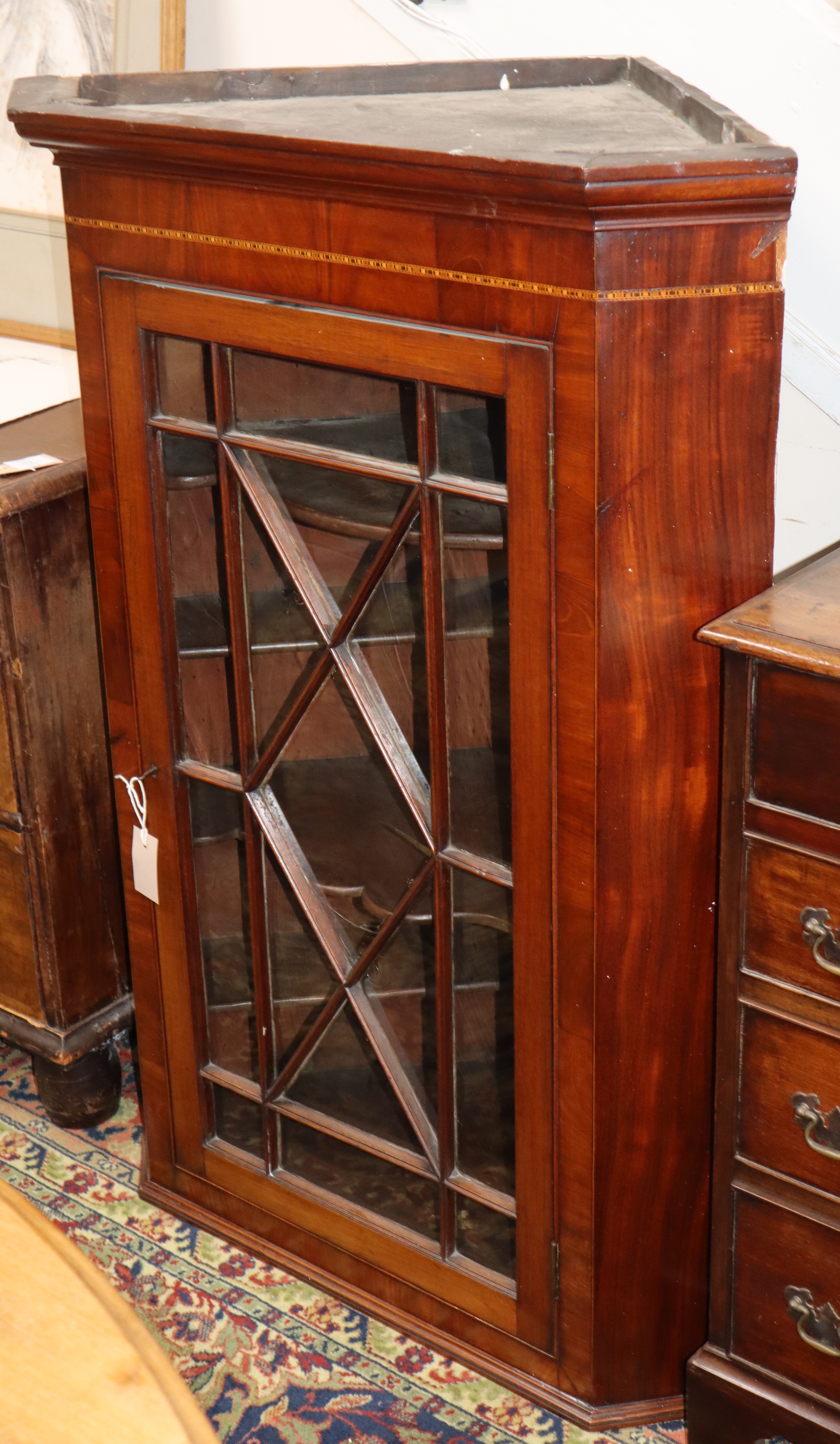 A George III inlaid mahogany hanging corner cabinet W.80cm