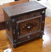 An inlaid oak spice cabinet, carved with the date, 1672 W.29cm