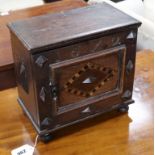 An inlaid oak spice cabinet, carved with the date, 1672 W.29cm