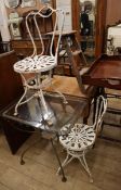 A wrought iron rectangular glass top garden table and two chairs Table W.76cm