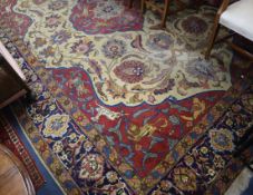 A Tabriz carpet woven with hunting scenes around a central floral medallion 300 x 144cm