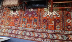 A Kazak style brick red ground carpet 250 x 170cm