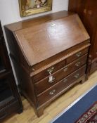 A small George III oak bureau W.83cm