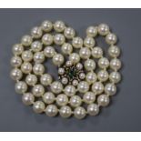 A single string of uniform cultured pearls with 14ct gold, pearl and emerald-set clasp, 48cm.