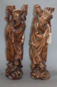 A pair of Chinese carved hardwood figures of sages height 53cm