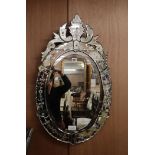 A Venetian engraved oval wall mirror H.82cm