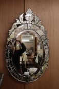 A Venetian engraved oval wall mirror H.82cm