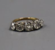 An early 20t century 18ct and plat, graduated five stone old mine cut diamond half hoop ring, the