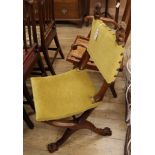 An early 20th century French carved walnut X frame side chair