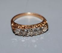A diamond five-stone half-hoop ring with yellow metal scrolled setting and shank (tests as 14ct),
