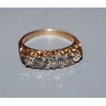 A diamond five-stone half-hoop ring with yellow metal scrolled setting and shank (tests as 14ct),