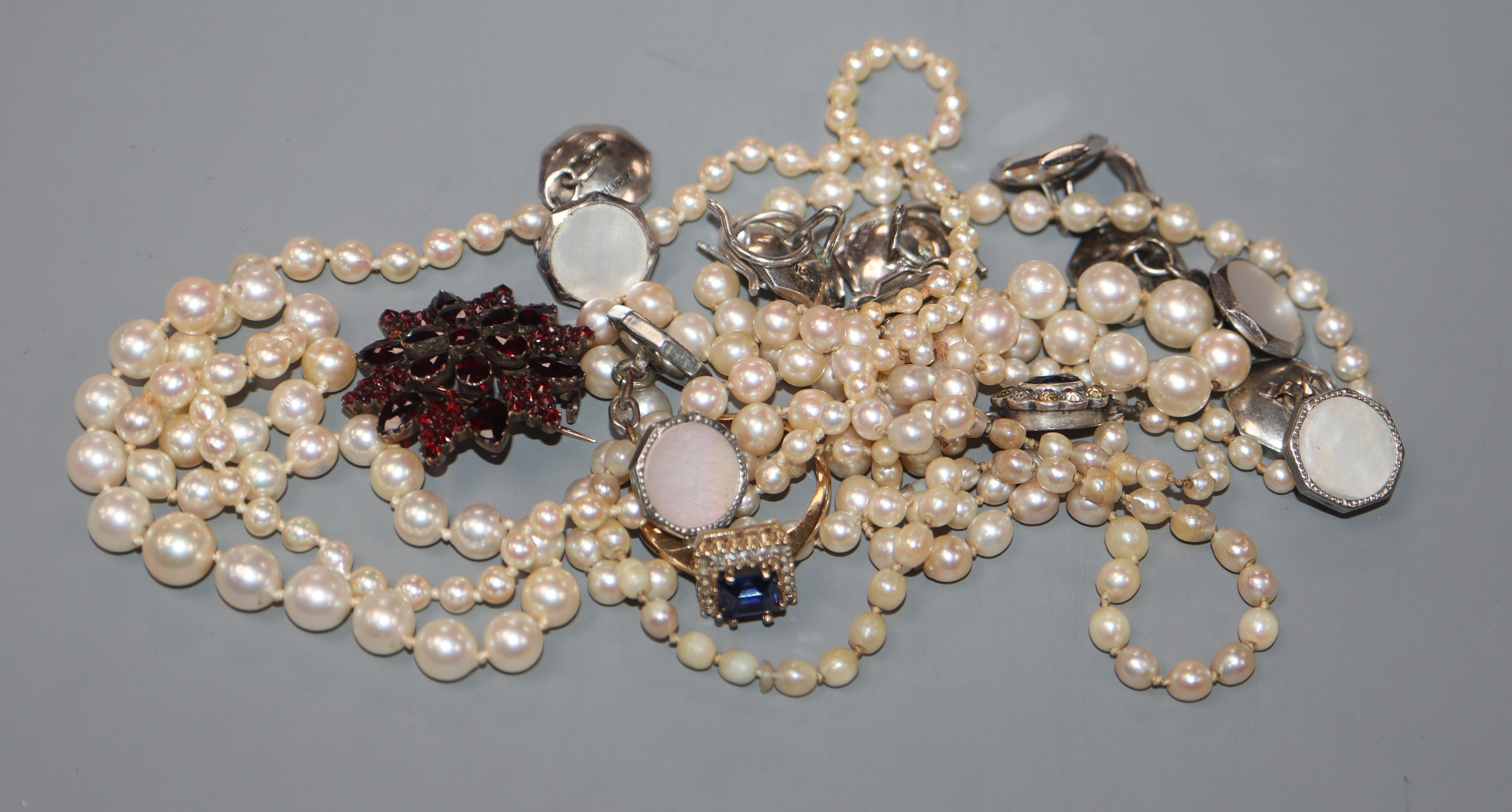 Three assorted cultured pearl necklaces, a Victorian yellow metal and garnet brooch, a 9ct ring