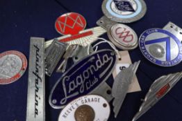 A group of motor car badges including Lagonda and Aston Martin