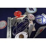 A group of motor car badges including Lagonda and Aston Martin