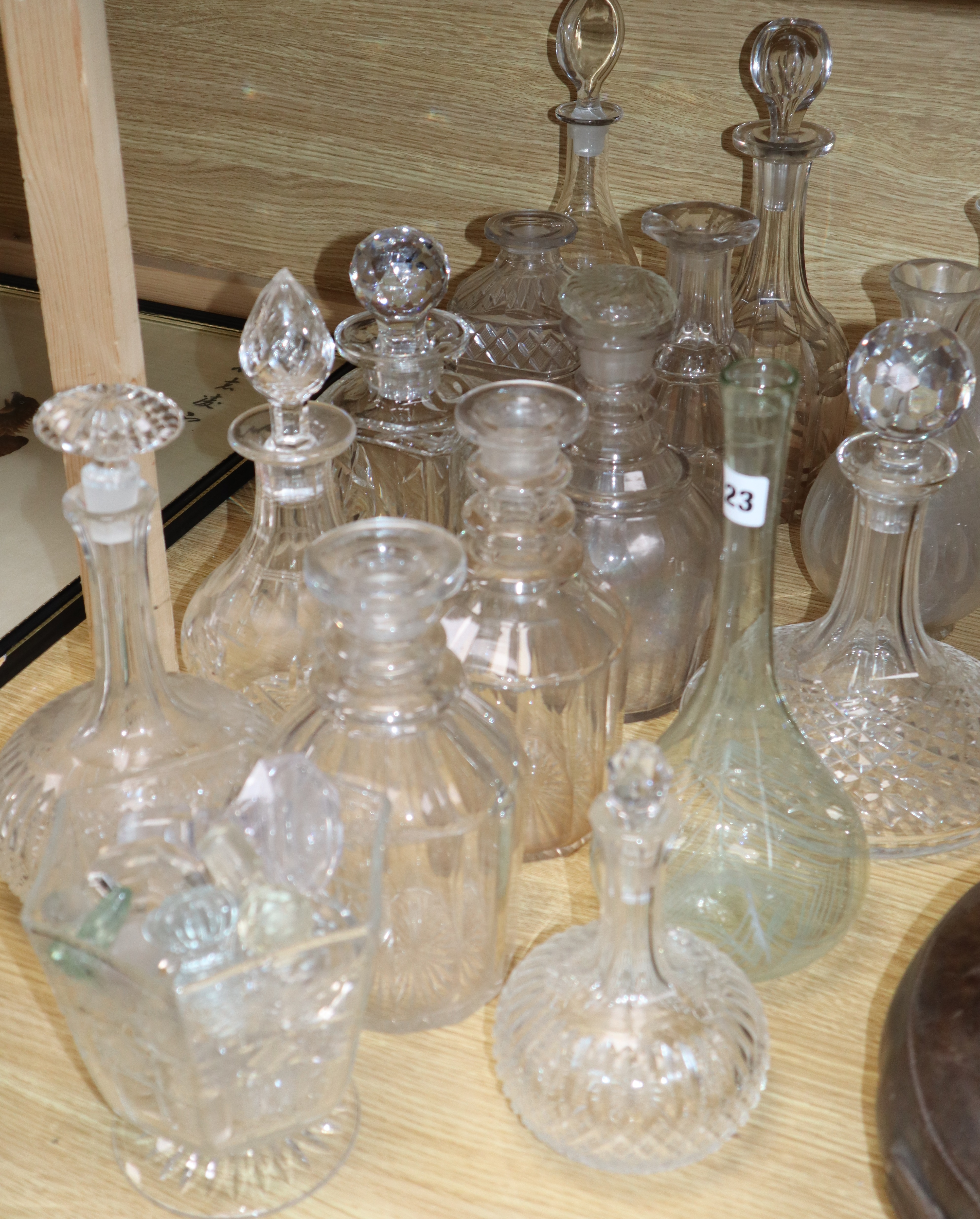 A collection of cut glass decanters and stoppers