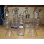 A collection of decanters, ewers and funnels