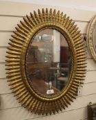An oval gilt metal foliate wall mirror H.75cm