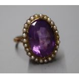 A 19th century yellow metal, amethyst and seed pearl set oval dress ring, size N/O.