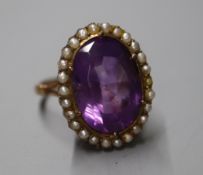 A 19th century yellow metal, amethyst and seed pearl set oval dress ring, size N/O.