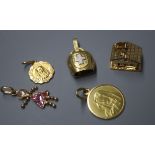Four 18ct gold charms, comprising a cow bell, a chalet and two Madonnas and a 9ct gold gem-set