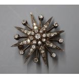 A Victorian yellow metal and diamond set starburst pendant brooch, 31mm.