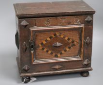 An inlaid oak spice cabinet, carved with the date, 1672 W.29cm