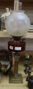 A brass and cranberry glass oil lamp height 70cm