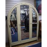 A French Art Deco painted arched three door wardrobe H.200cm