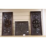 A 19th century carved oak panel and two later oak panels