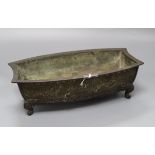 A Japanese Meiji bronze bonsai planter of shaped rectangular form cast with shells, on scrolled