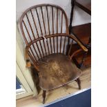 A Victorian yew and elm comb back Windsor armchair