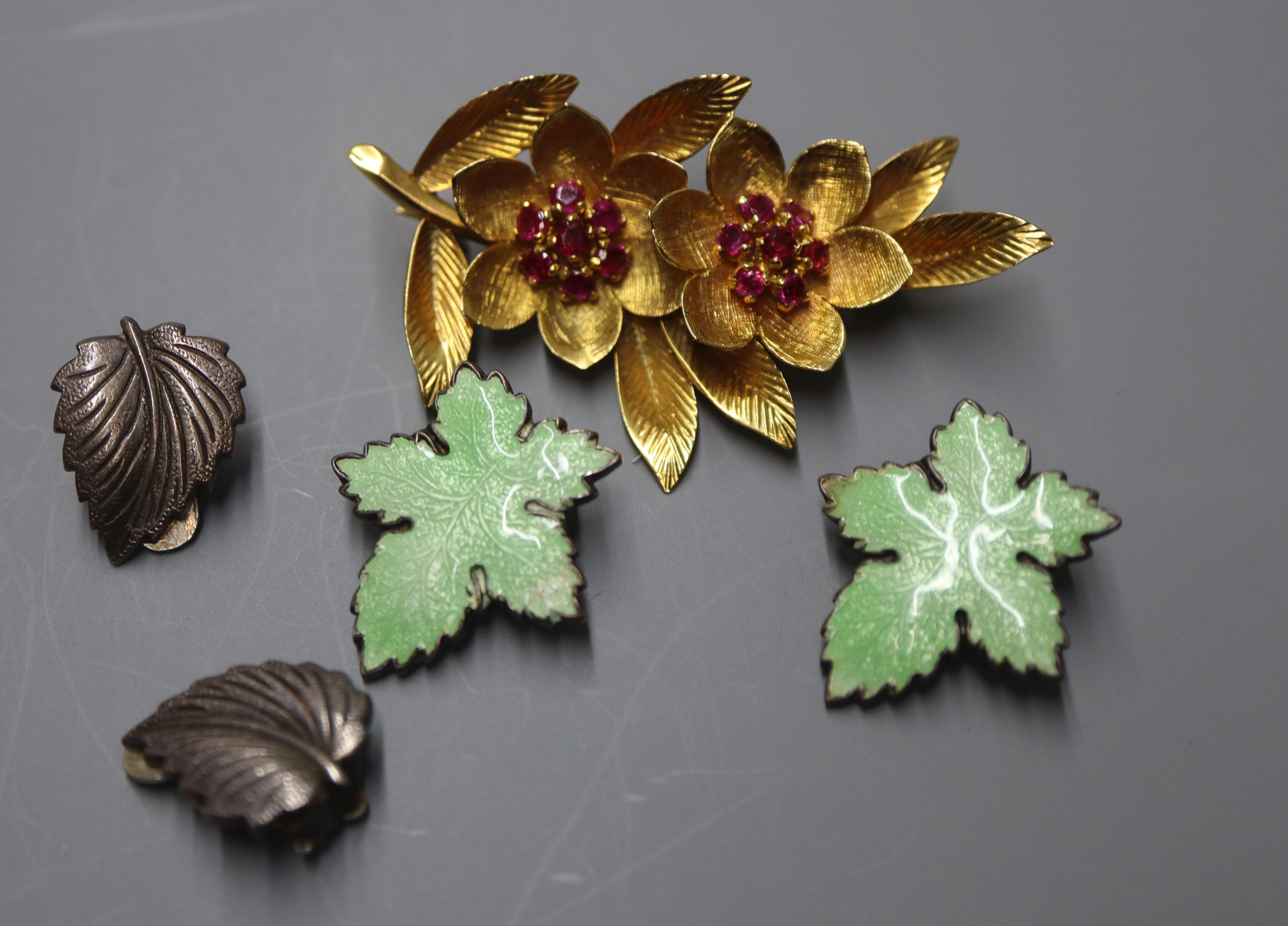 A yellow metal and ruby set leaf brooch and two pairs of white metal earrings including enamel.