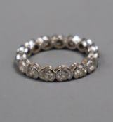 A modern 18ct white gold and diamond full eternity ring, set with fifteen part collet set round