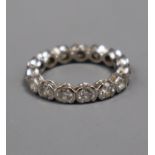 A modern 18ct white gold and diamond full eternity ring, set with fifteen part collet set round