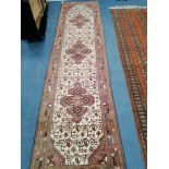 A Caucasian design red and cream ground runner approx. 300 x 80cm