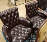 A pair of button leather tub armchairs