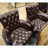 A pair of button leather tub armchairs