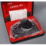 A Leitz black Leica R4 body in presentation box, a Zeiss Ikon Super Ikonta folding bellows camera