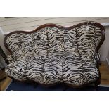 A French Victorian mahogany double spoon back settee upholstered in faux zebra fabric W.180cm