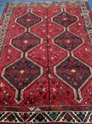 A Belouch red ground carpet 244 x 180cm
