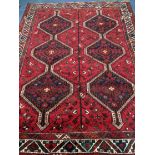 A Belouch red ground carpet 244 x 180cm