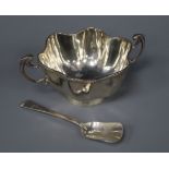 An Edwardian silver two handled sugar bowl and a later silver spoon.