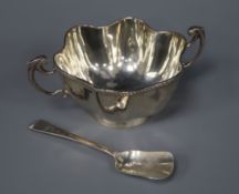 An Edwardian silver two handled sugar bowl and a later silver spoon.