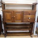 An oak 'cheese press' bookcase fitted cupboards and drawers W.148cm