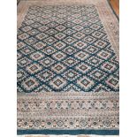 A teal ground Persian design carpet 366 x 270cm