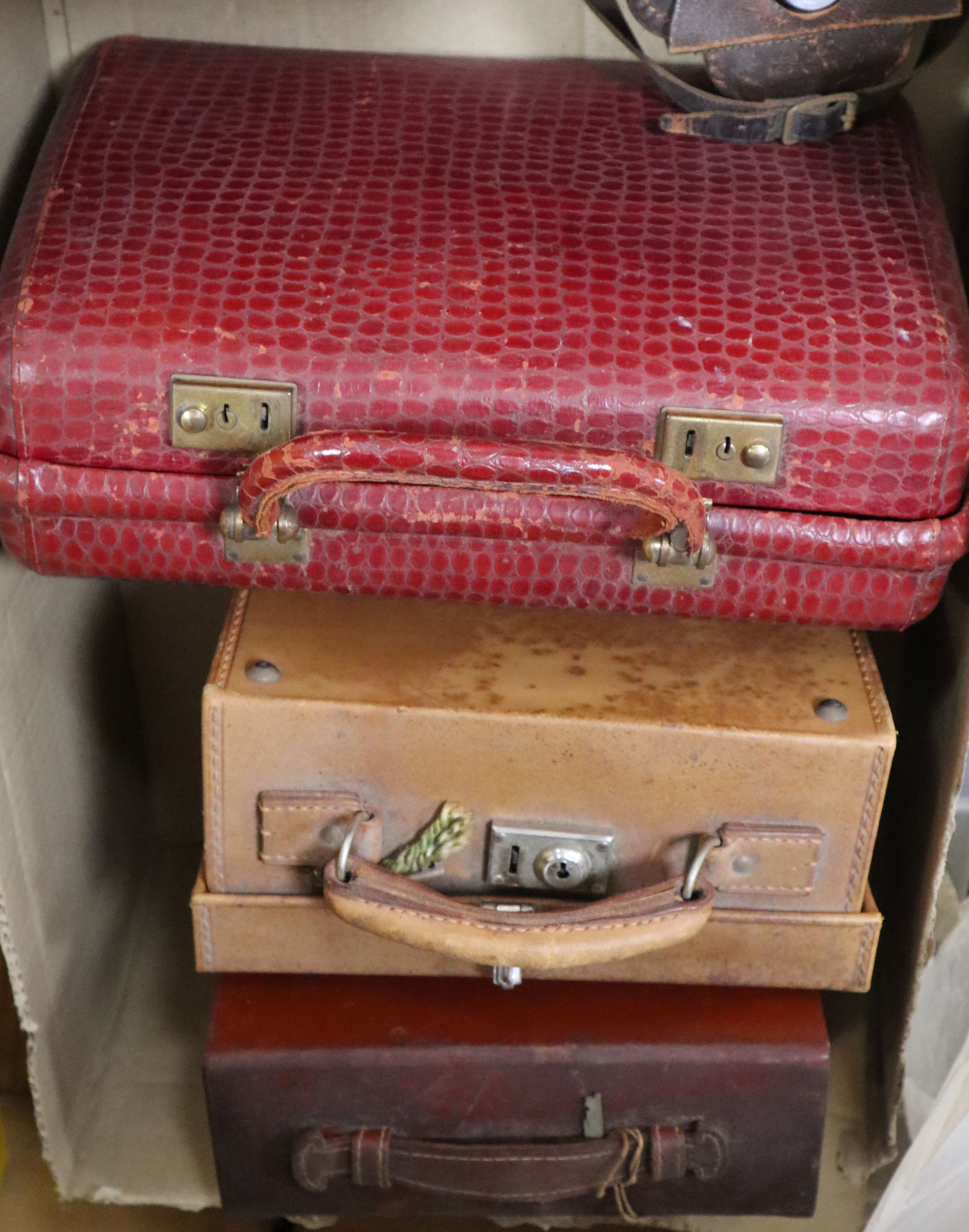 A hand bag, two toilet cases and a camera