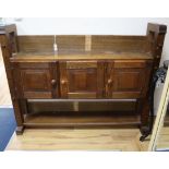 A small oak 'cheese press' bookcase , the cupboard enclosed by three doors W.150cm