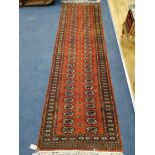 A Bokhara style red ground runner 270 x 80cm