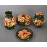 A Moorcroft hibiscus vase, two lidded jars and a pin dish vase 14cm